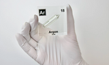 Clear acrylic cube displaying an Argon element (Atomic Number 18) embedded within, offering a scientific presentation for collectors and science enthusiasts.