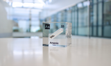 Arsenic element encased in a clear acrylic cube, showcasing its name, atomic number 33, and key properties from the periodic table. An informative and visually striking piece ideal for educational purposes and collectors.