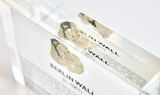Clear acrylic display case featuring a historical fragment of the Berlin Wall, providing an authentic and educational presentation for history enthusiasts and collectors.