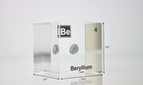 Clear acrylic cube encasing a Beryllium ampule with its atomic number 4. Ideal for display in educational settings, scientific collections, or as a decorative piece.