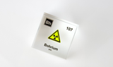 Clear acrylic cube displaying a Bohrium element (Atomic Number 107) embedded within, offering a scientific presentation for collectors and science enthusiasts. Radiation symbol.