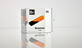 Clear acrylic cube displaying a Bromine element (Atomic Number 35) embedded within, offering a scientific presentation for collectors and science enthusiasts.