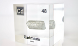 Clear acrylic cube displaying a Cadmium element (Atomic Number 48) embedded within, offering a scientific presentation for collectors and science enthusiasts.