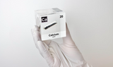 Clear acrylic cube displaying a Calcium element (Atomic Number 20) embedded within, offering a scientific presentation for collectors and science enthusiasts.