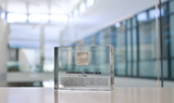 Clear acrylic display case featuring a historical fragment of a Chernobyl medic box, offering an educational presentation for collectors and those interested in nuclear history.