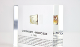 Clear acrylic display case featuring a historical fragment of a Chernobyl medic box, offering an educational presentation for collectors and those interested in nuclear history.