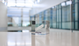 Clear acrylic cube displaying a Chlorine element (Atomic Number 17) embedded within, offering a scientific presentation for collectors and science enthusiasts.