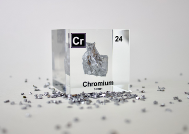 Chromium enclosed in a clear acrylic cube, highlighting its name, atomic number 24, and key properties from the periodic table. A great educational tool and collector’s piece.