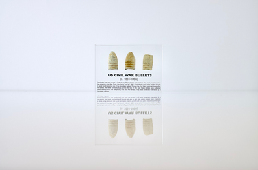 Clear acrylic display case featuring historical Civil War bullets, offering an educational presentation for collectors and enthusiasts of American history.