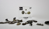 Cobalt element, Atomic Number 27, in a clear acrylic cube, displaying its name, atomic number, and key properties as shown on the periodic table. An educational and informative piece ideal for science enthusiasts and collectors.