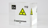 Clear acrylic cube displaying a Copernicium element (Atomic Number 112) embedded within, offering a scientific presentation for collectors and science enthusiasts.