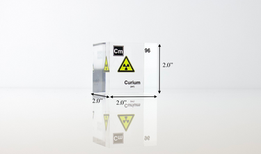Clear acrylic cube displaying a Curium element (Atomic Number 96) embedded within, offering a scientific presentation for collectors and science enthusiasts.