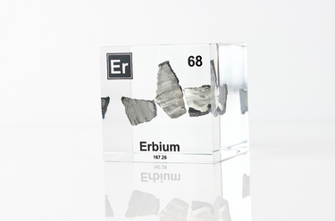 Clear acrylic cube displaying an Erbium element (Atomic Number 68) embedded within, offering a scientific presentation for collectors and science enthusiasts.