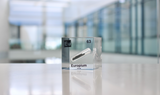 Clear acrylic cube displaying an Europium element (Atomic Number 63) embedded within, offering a scientific presentation for collectors and science enthusiasts.