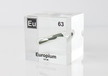 Clear acrylic cube displaying an Europium element (Atomic Number 63) embedded within, offering a scientific presentation for collectors and science enthusiasts.