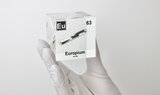 Clear acrylic cube displaying an Europium element (Atomic Number 63) embedded within, offering a scientific presentation for collectors and science enthusiasts.
