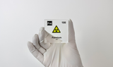 Clear acrylic cube displaying a Fermium element (Atomic Number 100) embedded within, offering a scientific presentation for collectors and science enthusiasts.