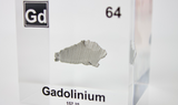 Clear acrylic cube displaying a Gadolinium element (Atomic Number 64) embedded within, offering a scientific presentation for collectors and science enthusiasts.