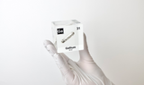 Gallium element being held by a chemist, encased in a clear acrylic cube, featuring its name, atomic number 31, and properties as displayed on the periodic table. Ideal for educational and collector use.