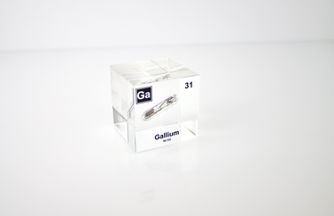 Gallium element encased in a clear acrylic cube, featuring its name, atomic number 31, and properties as displayed on the periodic table. Ideal for educational and collector use.