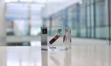 Clear acrylic cube displaying an Iodine element (Atomic Number 53) embedded within, offering a scientific presentation for collectors and science enthusiasts.