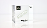 Clear acrylic cube displaying a Krypton element (Atomic Number 36) embedded within, offering a scientific presentation for collectors and science enthusiasts.