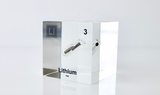 Clear acrylic cube displaying a Lithium element (Atomic Number 3) embedded within, offering a scientific presentation for collectors and science enthusiasts.