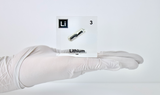Clear acrylic cube displaying a Lithium element (Atomic Number 3) embedded within, offering a scientific presentation for collectors and science enthusiasts.