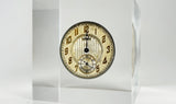 Clear acrylic display case showcasing a detailed watch face with hands and markers, offering a stylish presentation for watch enthusiasts and collectors.