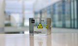 Clear acrylic cube displaying a Nihonium element (Atomic Number 113) embedded within, offering a scientific presentation for collectors and science enthusiasts.