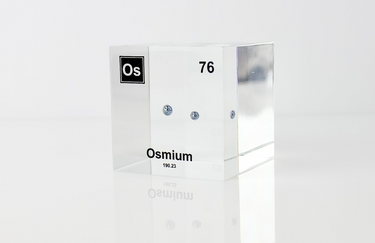 Piece of Osmium encased in a clear acrylic cube, with the element's name, atomic number, and properties displayed as on the periodic table for a sleek, educational display.