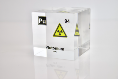 Clear acrylic cube displaying a Plutonium element (Atomic Number 94) embedded within, offering a scientific presentation for collectors and science enthusiasts.