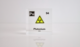 Clear acrylic cube displaying a Plutonium element (Atomic Number 94) embedded within, offering a scientific presentation for collectors and science enthusiasts.