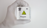 Clear acrylic cube displaying a Plutonium element (Atomic Number 94) embedded within, offering a scientific presentation for collectors and science enthusiasts.