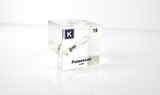 Clear acrylic cube displaying a Potassium element (Atomic Number 19) embedded within, offering a scientific presentation for collectors and science enthusiasts.