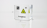 Clear acrylic cube displaying a Promethium element (Atomic Number 61) embedded within, offering a scientific presentation for collectors and science enthusiasts.