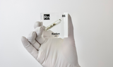 Clear acrylic cube displaying a Radon element (Atomic Number 86) embedded within, offering a scientific presentation for collectors and science enthusiasts.