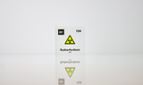 Clear acrylic cube displaying a Rutherfordium element (Atomic Number 104) embedded within, offering a scientific presentation for collectors and science enthusiasts.