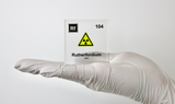 Clear acrylic cube displaying a Rutherfordium element (Atomic Number 104) embedded within, offering a scientific presentation for collectors and science enthusiasts.