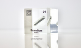 Clear acrylic cube displaying a Scandium element (Atomic Number 21) embedded within, offering a scientific presentation for collectors and science enthusiasts.