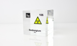 Clear acrylic cube displaying a Seaborgium element (Atomic Number 106) embedded within, offering a scientific presentation for collectors and science enthusiasts.