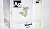Clear acrylic cube displaying a Silver element (Atomic Number 47) embedded within, offering a scientific presentation for collectors and science enthusiasts.