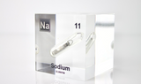 Clear acrylic cube containing a Sodium ampule, marked with its atomic number 11. Perfect for showcasing in educational environments, scientific collections, or as a unique decorative element.