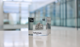 Clear acrylic cube displaying a Tellurium element (Atomic Number 52) embedded within, offering a scientific presentation for collectors and science enthusiasts.