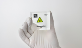 Clear acrylic cube displaying a Tennessine element (Atomic Number 117) embedded within, offering a scientific presentation for collectors and science enthusiasts.