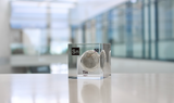 Clear acrylic cube displaying a Tin element (Atomic Number 50) embedded within, offering a scientific presentation for collectors and science enthusiasts.