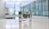 Clear acrylic cube displaying a Titanium element (Atomic Number 22) embedded within, offering a scientific presentation for collectors and science enthusiasts.