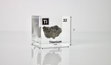 Clear acrylic cube displaying a Titanium element (Atomic Number 22) embedded within, offering a scientific presentation for collectors and science enthusiasts.