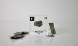 Clear acrylic cube displaying a Titanium element (Atomic Number 22) embedded within, offering a scientific presentation for collectors and science enthusiasts.