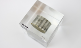 Clear acrylic cube displaying a Tungsten element (Atomic Number 74) embedded within, offering a scientific presentation for collectors and science enthusiasts.